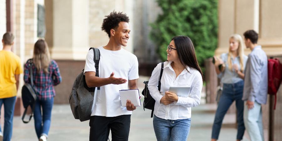 Male and female student walking to class together
