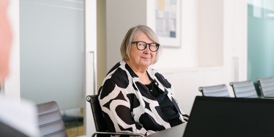 Gloria smiling at desk