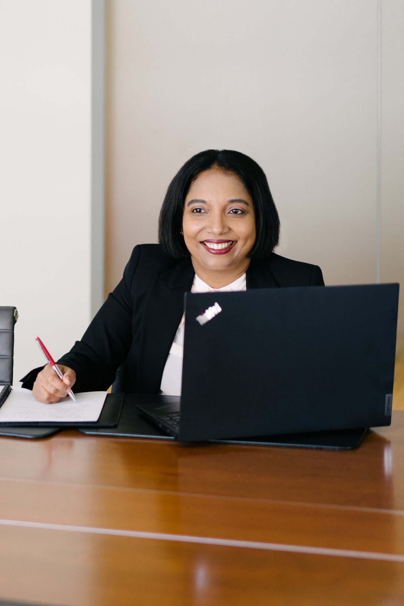 Swarna smiling in front of laptop